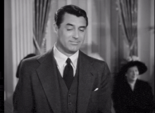 a black and white photo of a man in a suit