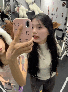 a girl is taking a selfie with a phone that says ' s ' on it