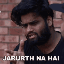 a man with a beard is making a funny face with the words jarruth na hai below him