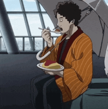 a man is sitting under an umbrella with a plate of food in front of him