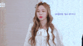 a girl with a flower crown on her head is wearing a white shirt