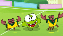 three crabs wearing yellow and green shirts are dancing on a soccer field