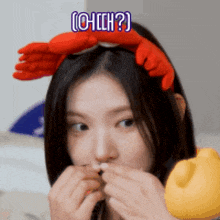 a woman wearing a headband with crabs on it