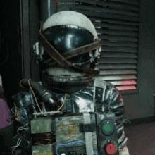 a person wearing a helmet and holding a device that says spark boston