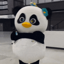a panda mascot is holding a can of soda in its hand
