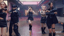 a group of women are dancing together in a dark room