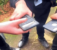 a man in a suit is holding a calculator in his hands
