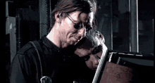 a man wearing sunglasses and a black shirt is looking at something