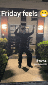 a man is dancing in front of a building that says friday feels on it