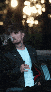 a man with a tattoo on his face is smoking