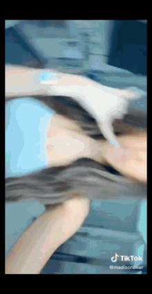 a tiktok video of a woman 's hair being blown by the wind