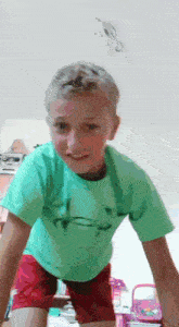 a young boy in a green under armour shirt