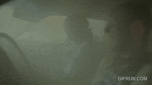 a man is driving a car with smoke coming out of the window .