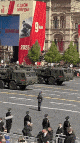 a military parade with a banner that says 9 man on it