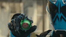 a person wearing a helmet and holding a green object