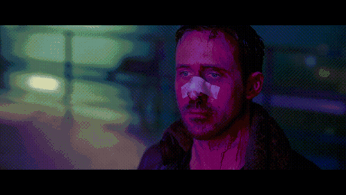 a pixelated image of a man with a bandage on his nose in a dark room