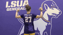 a girl wearing a purple jersey with the number 27