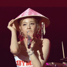 a woman wearing a pink hat has a tag that says summer staff on it