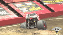 a monster jam logo is on the ground in front of a monster truck