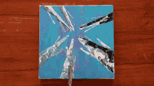 a painting on a wooden table that looks like a star