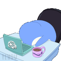 a blue penguin is laying on a desk with a laptop and a cup of coffee