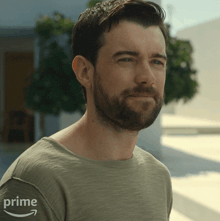 a man with a beard wears a shirt that says prime on it