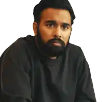 a man with a beard is wearing a black sweatshirt