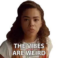 a woman with curly hair has the words the vibes are weird on her face
