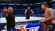 a wrestling match is taking place in a stadium with a sign that says ' smack live '