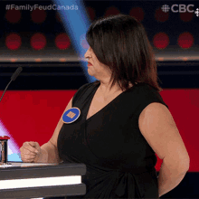 a woman in a black dress with a name tag that says kim on it