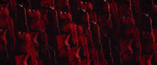 a red and blue background with a few white dots