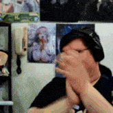 a man wearing headphones holds a glass in front of a wall with a picture of a girl on it