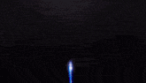 a computer generated image of a purple and blue light