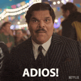 a man in a suit and tie says adios on a netflix advertisement