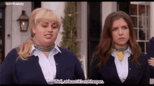 two women are standing next to each other and one of them is talking about herpes .