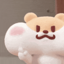 a close up of a stuffed animal with an angry face