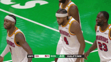 three warriors basketball players standing on a green court