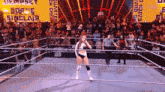 a woman in a wrestling ring with the word sinclair on the wall