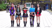 a group of girls are standing next to each other on a sidewalk