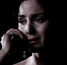 a woman crying while talking on a nokia cell phone