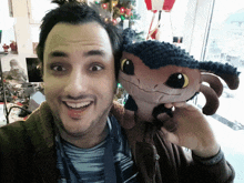 a man holds a stuffed animal in front of his face