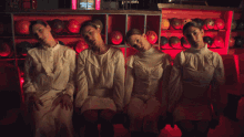 a group of women sitting in front of a bowling alley