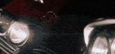 a close up of a car 's headlights with a black background