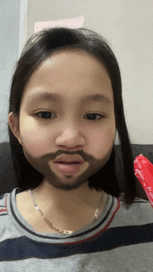 a girl with a fake beard is wearing a striped shirt and a necklace