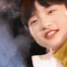 a close up of a person 's face with a blurred background