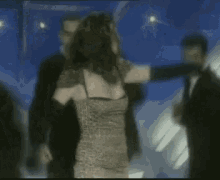 a woman in a dress is being held by a group of men .