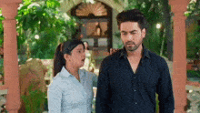 a man and a woman are standing next to each other and talking .
