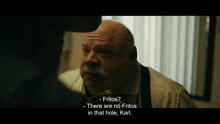 a man with a mustache is talking to another man and says fritos there are no fritos in that hole