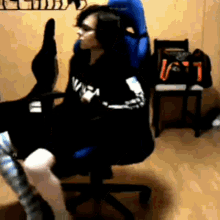 a woman is sitting in a chair with a bag that says ' lg ' on it