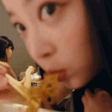 a close up of a person eating food with chopsticks